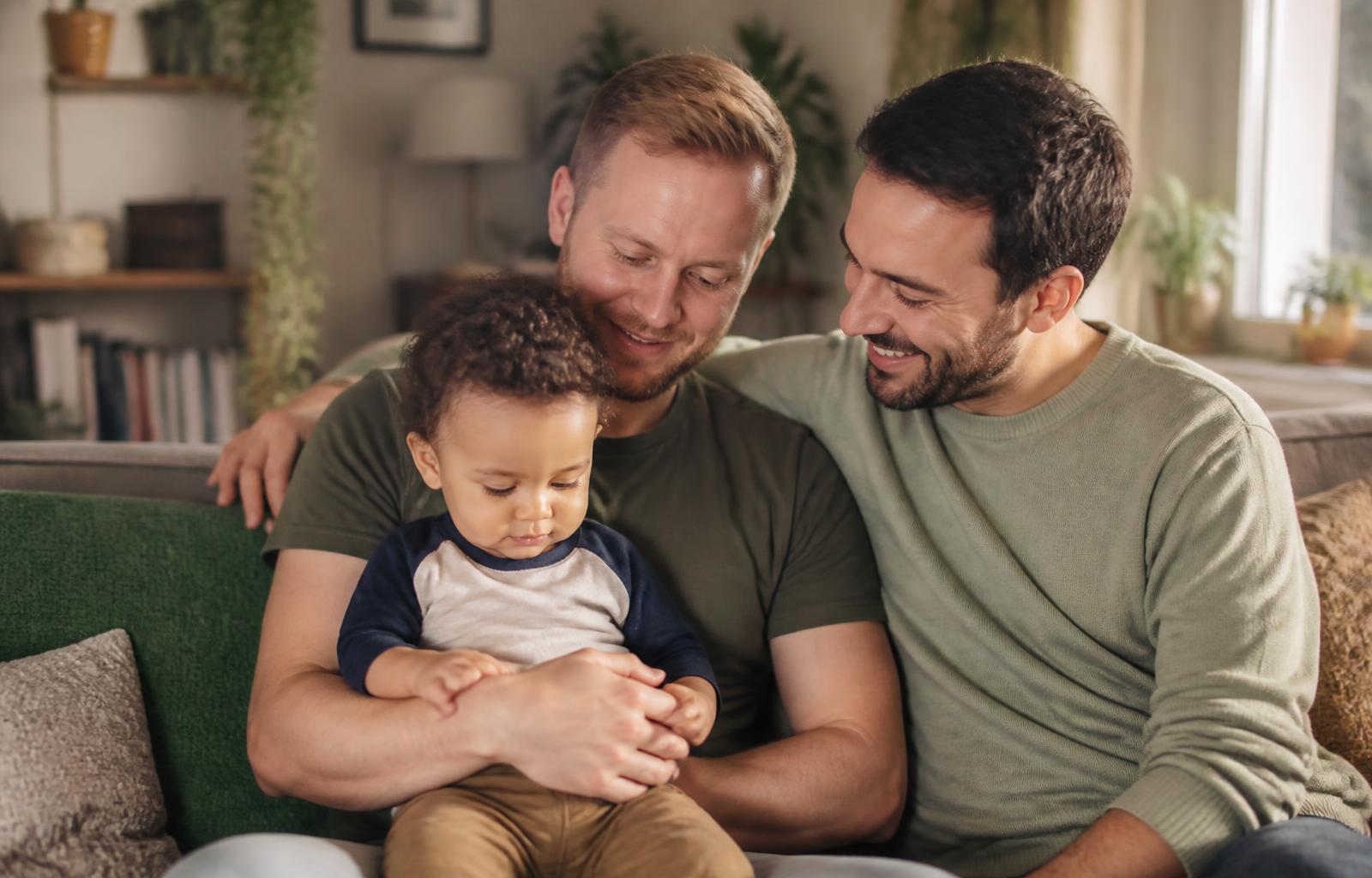 Same-sex couple with their toddler in a cozy living room