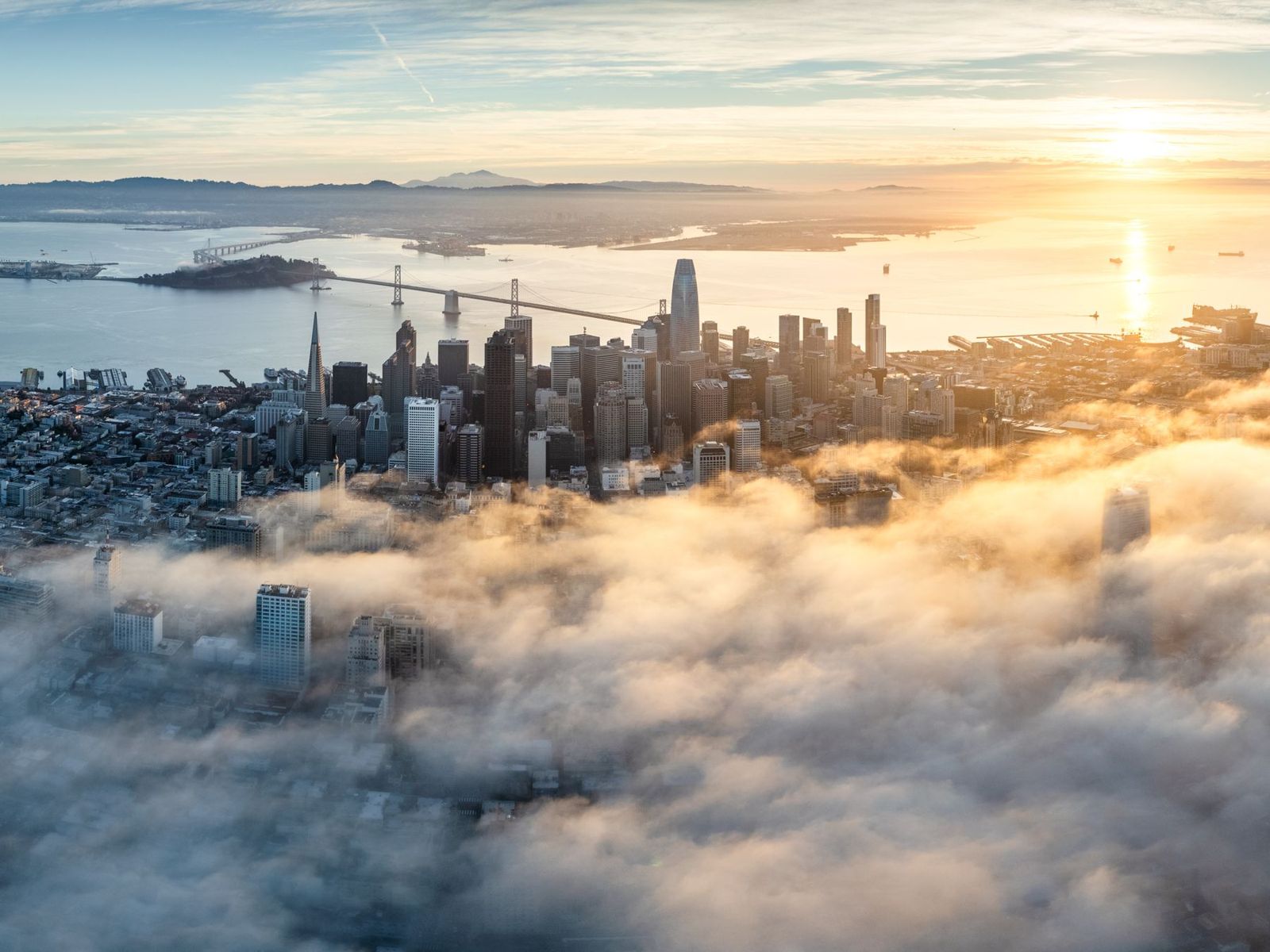 San Francisco skyline rising above morning fog at sunrise